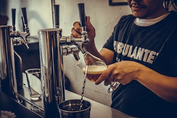 Man Pouring Beer On Glass