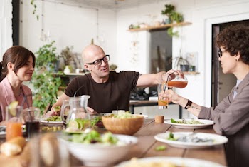 Man Pouring Drink on Woman's Glass