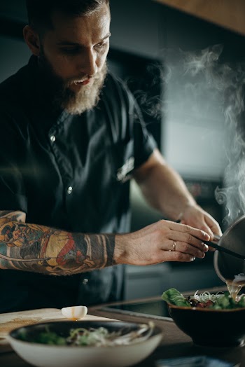 Man Pouring Soup in Bowl
