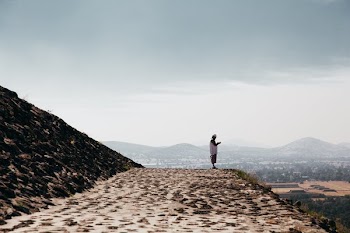 Man Prays On Stone Temple Ledge