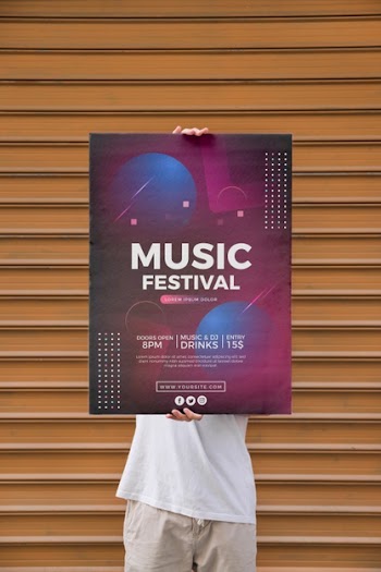 Man presenting poster mockup in front of wall Free Psd