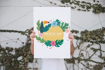 Man presenting poster mockup outdoors Free Psd