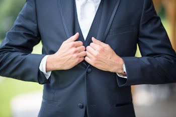 Man Pulling Down His Suit Jacket