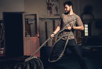 Man Pulling Rope Tied on Truck Tire