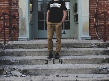 man put his hand on his pocket while standing on stair