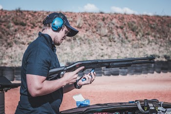 Man Putting Bullet in Shotgun