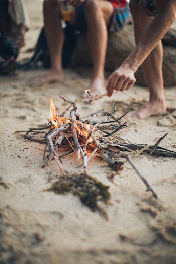 Man Putting Stick on Fire