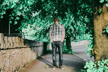Man Putting Two Hands on Pocket Standing Near Tree