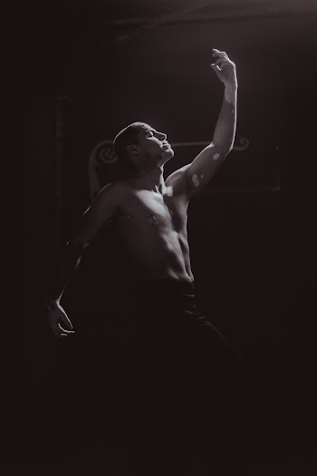 Man Raising His Left Hand