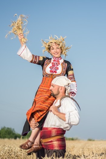 Man Raising Woman Through Shoulder