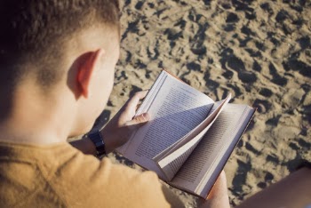 Man Reading Book at Sandy Plains