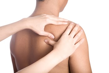 Man receiving massage on back of shoulder due to injury.