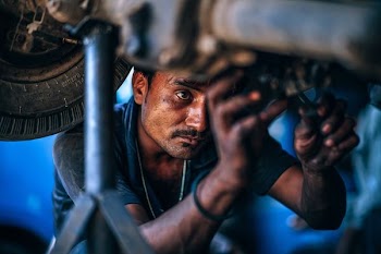 man repairing vehicle