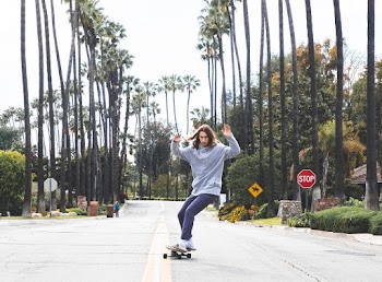 Man Riding A Longboard