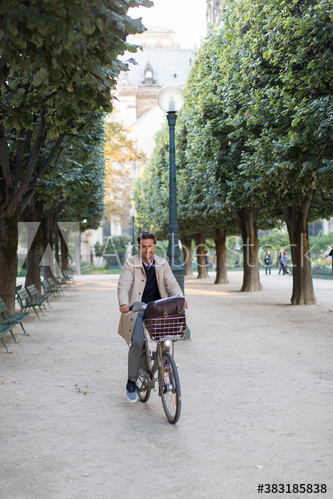 Man riding bicycle in park, Paris, France