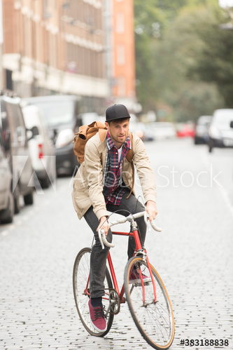 Man riding bicycle on city street
