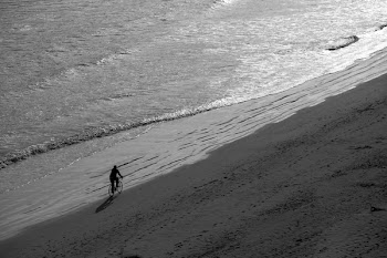 Man Riding Bike on Seashore