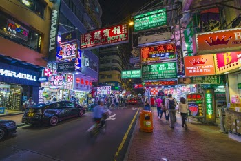 Man Riding Bike on Street during Nighttime