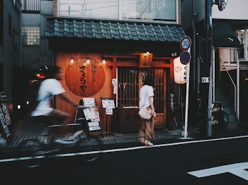 man riding bike passing near woman standing