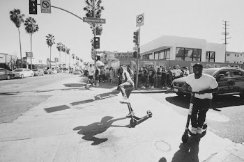 man riding kick scooter