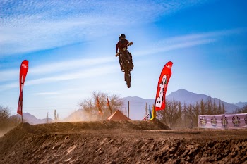 Man Riding Motocross Dirt Bike Doing Stunt