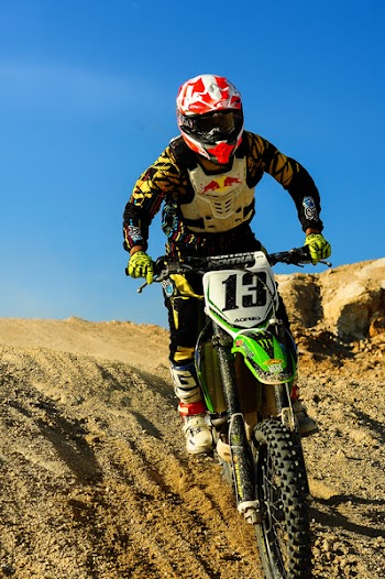 Man Riding Motocross Dirt Bike on Hill