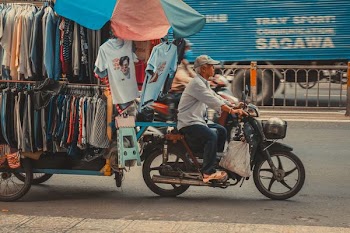 man riding on motor scooter
