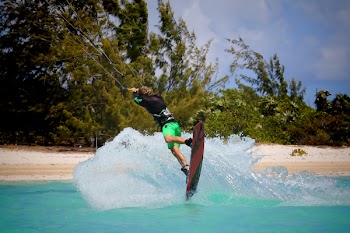 Man Riding on Red Board on Water