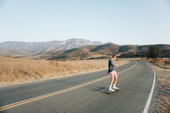 man riding on skateboard on road