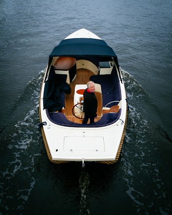 Man Riding on White and Brown Motorboat on Body of Water