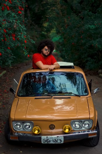 Man Riding Orange Volkswagen Vehicle