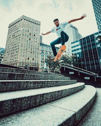 Man Riding Skateboard Doing Tricks On Stairs