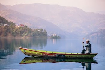 man riding yellow boat