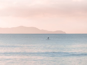 Man Rowing a Boat on Sea at Daytime
