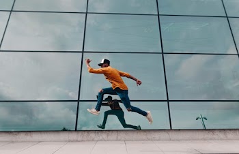 Man Running Beside Mirror Wall