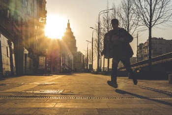 Man Running on Street during Sunset