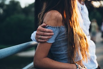 Man's Arm Around Woman