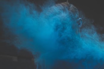 man's face covered with smoke