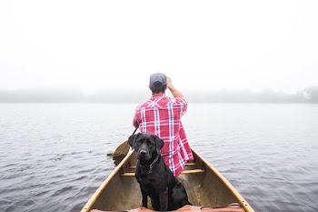 man sailing boat on body of water