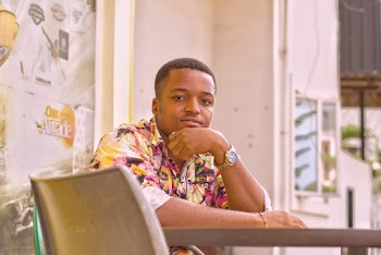 Man Seated alone at a Table Looking at the Camera