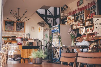 Man Seated at a Table in A Café