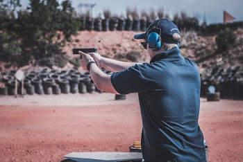 Man Shooting Gun in Fire Range