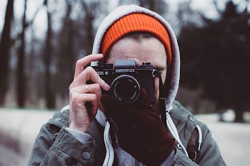 Man shooting with an analog camera