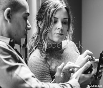 Man showing his smartphone to his friend