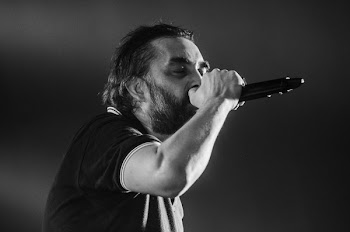 Man Singing Wearing Black Polo Shirt