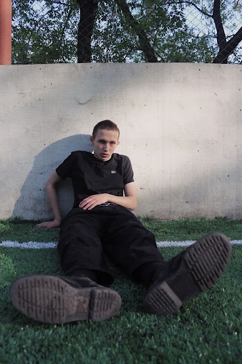 Man Siting On Grass Field