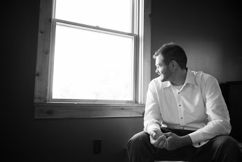 Man Sits on Chair While Looking on the Window