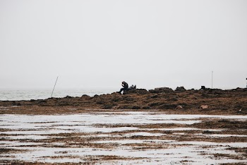 Man Sits on Stone