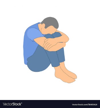 man sits sad in a closed position