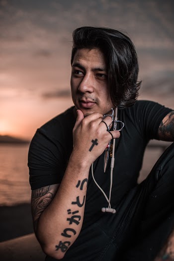 Man Sits While Holding His Chin
